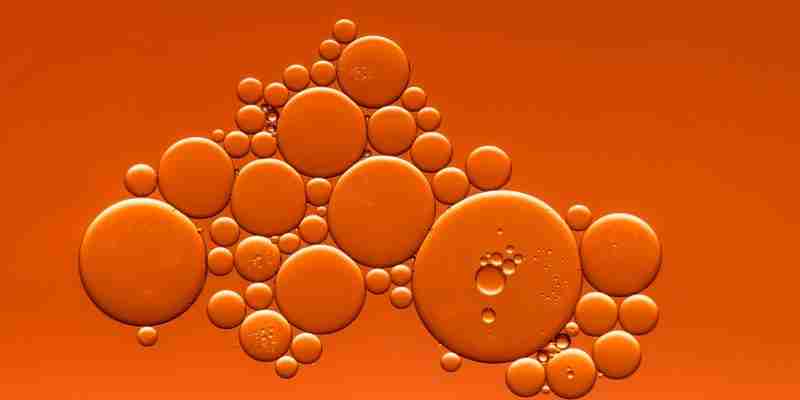 grouping of various size orange circles with orange background