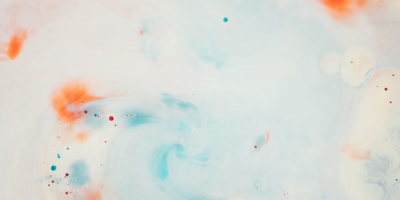abstract image of white background with blue, orange and red splotches