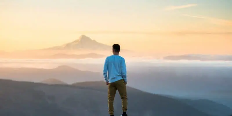 man looking toward the mountains