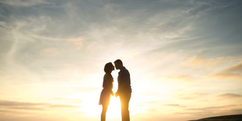 couple kissing in the sunset