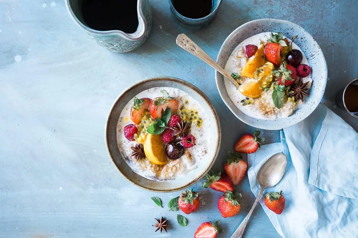 2 bowls of oatmeal with fresh fruit